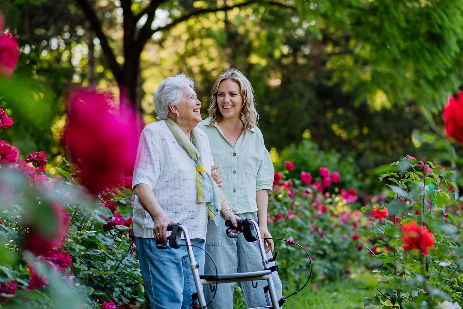 Grandmother and granddaughter enjoying a walk in a garden.
